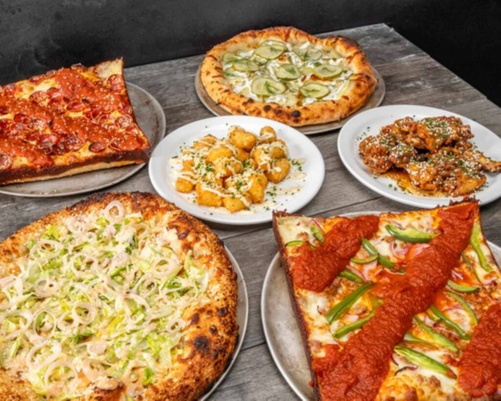 table full of pizza at a restaurant in st.catharines