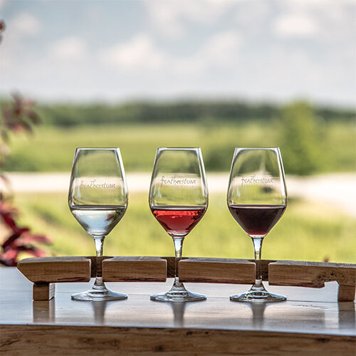 3 wine glasses with wine poured for a tasting